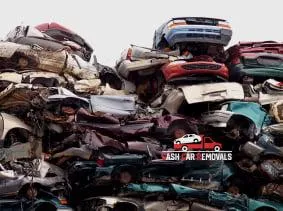 A massive pile of crushed and stacked scrap vehicles of various colors in our south Auckland scrapyard, showcasing recycling and auto salvage processes our car wreckers Auckland facility.